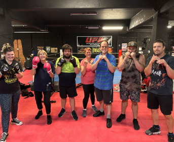 A group of people who work at Merriwa at a local boxing ring